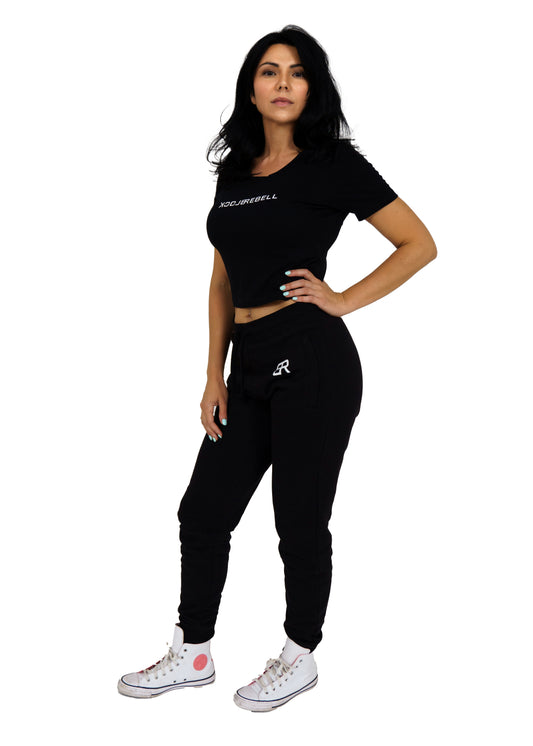 Frau trägt schwarzen BlockRebell Jogger und Cropped Shirt – sportliches Streetwear-Outfit für Damen